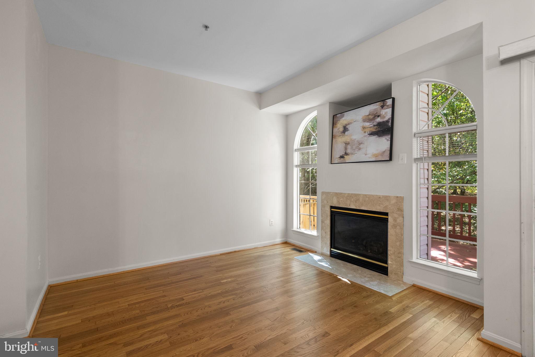 6710 Tranquil Way Elkridge, MD 21075 - Photo 5 of 49 a view of a livingroom with a fireplace and a window