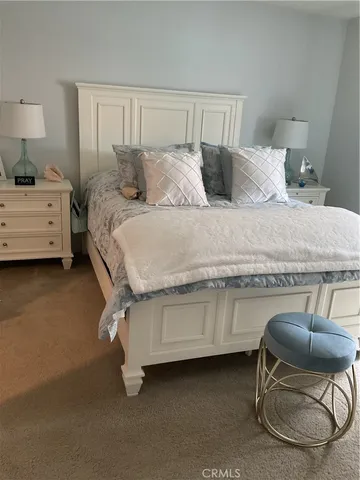 a bedroom with a bed chair and a chair