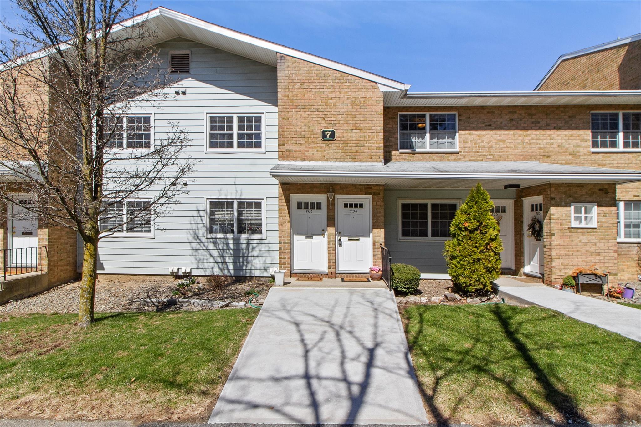 View of front of house featuring a front lawn and brick siding