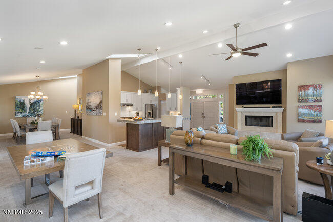 2522 Lake Ridge Shores Circle Reno, NV 89519 - Photo 11 of 50 a living room with furniture a fireplace and a flat screen tv