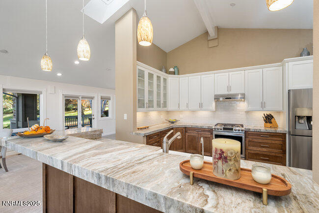 2522 Lake Ridge Shores Circle Reno, NV 89519 - Photo 12 of 50 a kitchen with stainless steel appliances granite countertop a sink stove and refrigerator