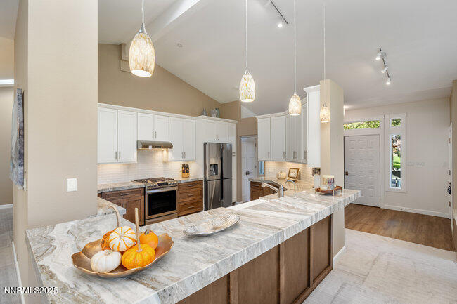 2522 Lake Ridge Shores Circle Reno, NV 89519 - Photo 13 of 50 a large kitchen with kitchen island a large counter top and stainless steel appliances