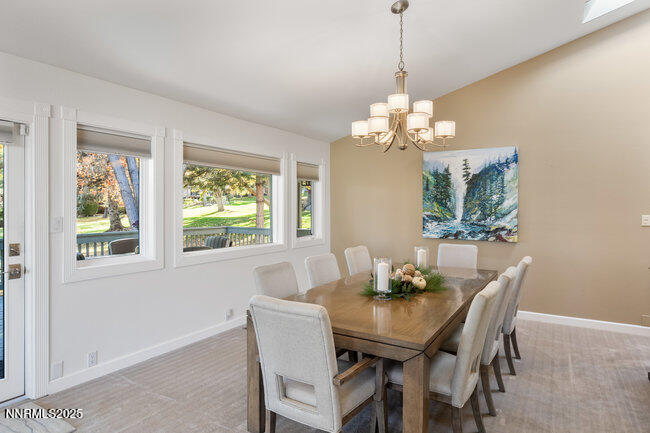 2522 Lake Ridge Shores Circle Reno, NV 89519 - Photo 16 of 50 a dining room with furniture a chandelier and a window