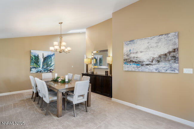 2522 Lake Ridge Shores Circle Reno, NV 89519 - Photo 17 of 50 a view of a dining room with furniture a chandelier and wooden floor