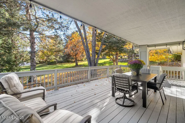 a balcony with wooden floor and outdoor seating