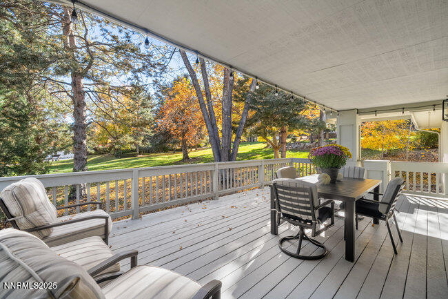 2522 Lake Ridge Shores Circle Reno, NV 89519 - Photo 18 of 50 a balcony with wooden floor and outdoor seating