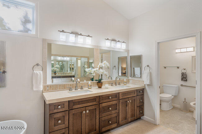 2522 Lake Ridge Shores Circle Reno, NV 89519 - Photo 28 of 50 a spacious bathroom with a double vanity sink a toilet and a mirror
