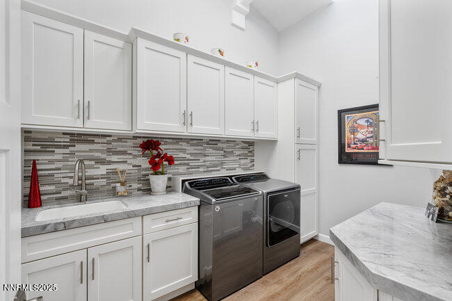 2522 Lake Ridge Shores Circle Reno, NV 89519 - Photo 30 of 50 a kitchen with granite countertop white cabinets and white appliances