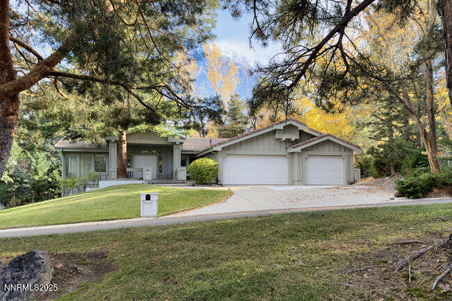 2522 Lake Ridge Shores Circle Reno, NV 89519 - Photo 49 of 50 a front view of house with yard and trees