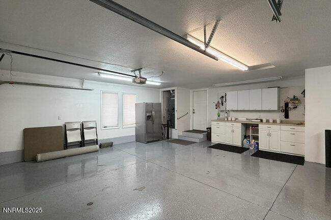 2522 Lake Ridge Shores Circle Reno, NV 89519 - Photo 50 of 50 a living room with furniture and a chandelier