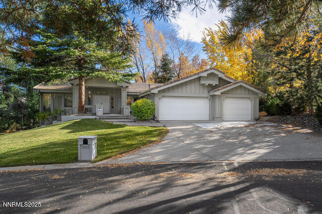 2522 Lake Ridge Shores Circle Reno, NV 89519 - Photo 5 of 50 a view of a house with a yard plants and large tree