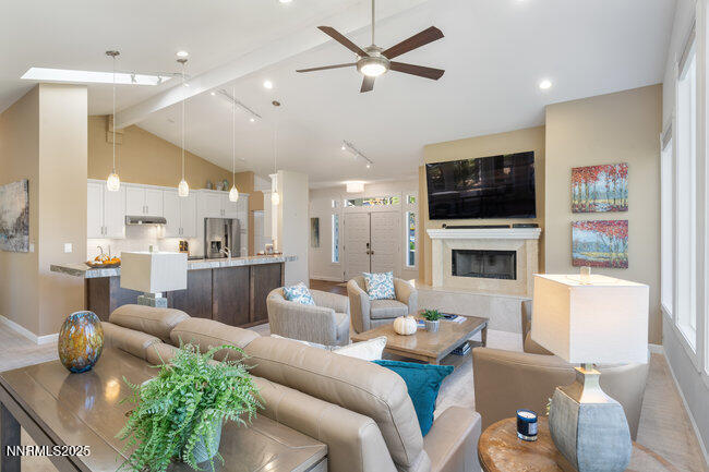 2522 Lake Ridge Shores Circle Reno, NV 89519 - Photo 9 of 50 a living room with furniture a fireplace and a flat screen tv