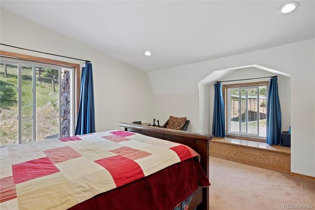 a bedroom with a large bed and a window