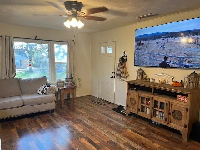 a kitchen with stainless steel appliances a table chairs and wooden floor