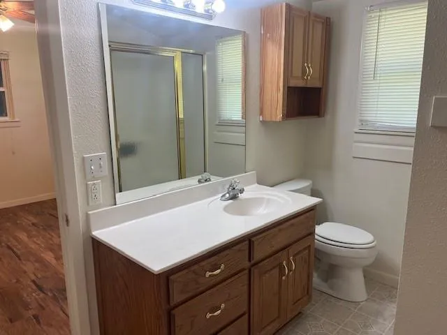 a bathroom with a sink toilet and mirror
