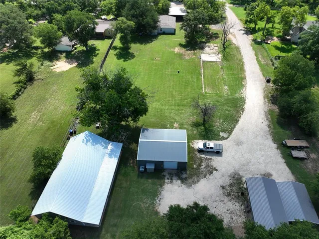 an aerial view of a house with a yard and lake view