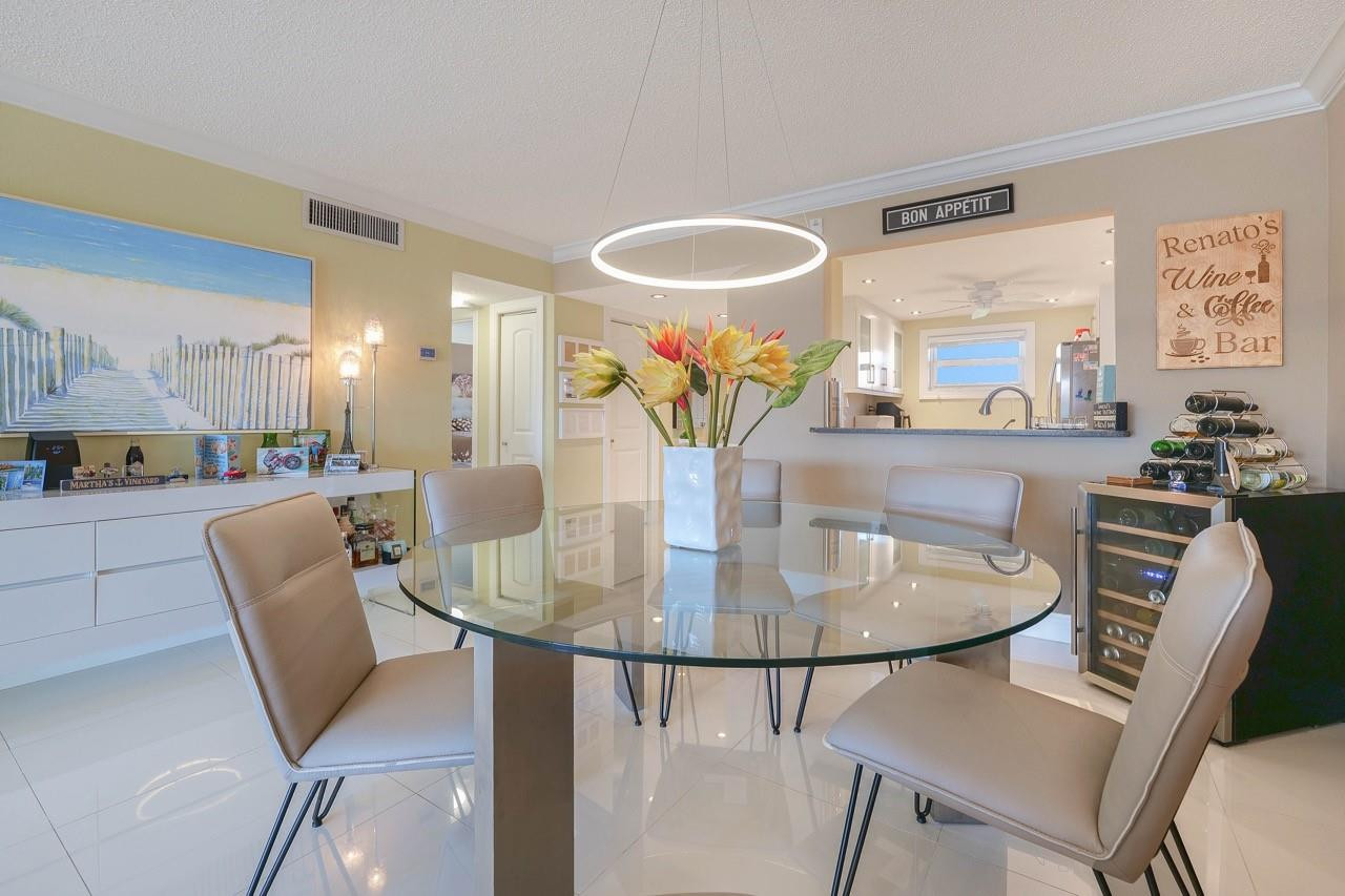 3930 Inverrary Boulevard, Unit 603D Lauderhill, FL 33319 - Photo 12 of 74 a dining room with furniture and a chandelier