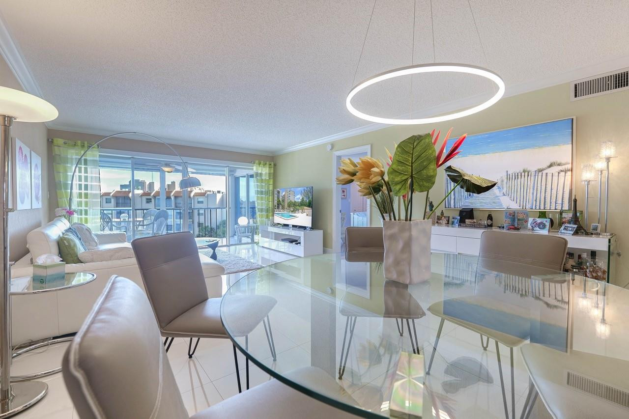 3930 Inverrary Boulevard, Unit 603D Lauderhill, FL 33319 - Photo 14 of 74 a dining room with furniture and a floor to ceiling window