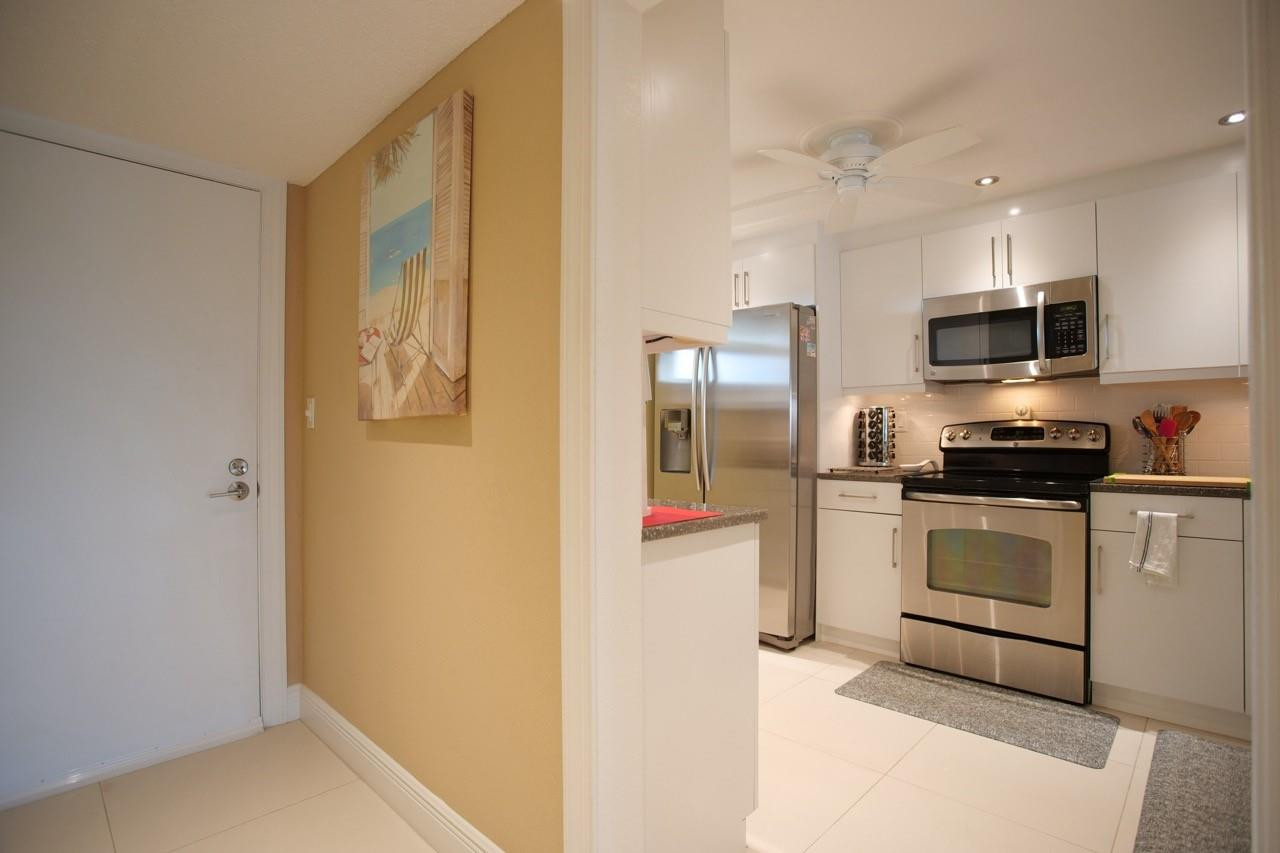 3930 Inverrary Boulevard, Unit 603D Lauderhill, FL 33319 - Photo 18 of 74 a kitchen with stainless steel appliances a refrigerator and a stove top oven