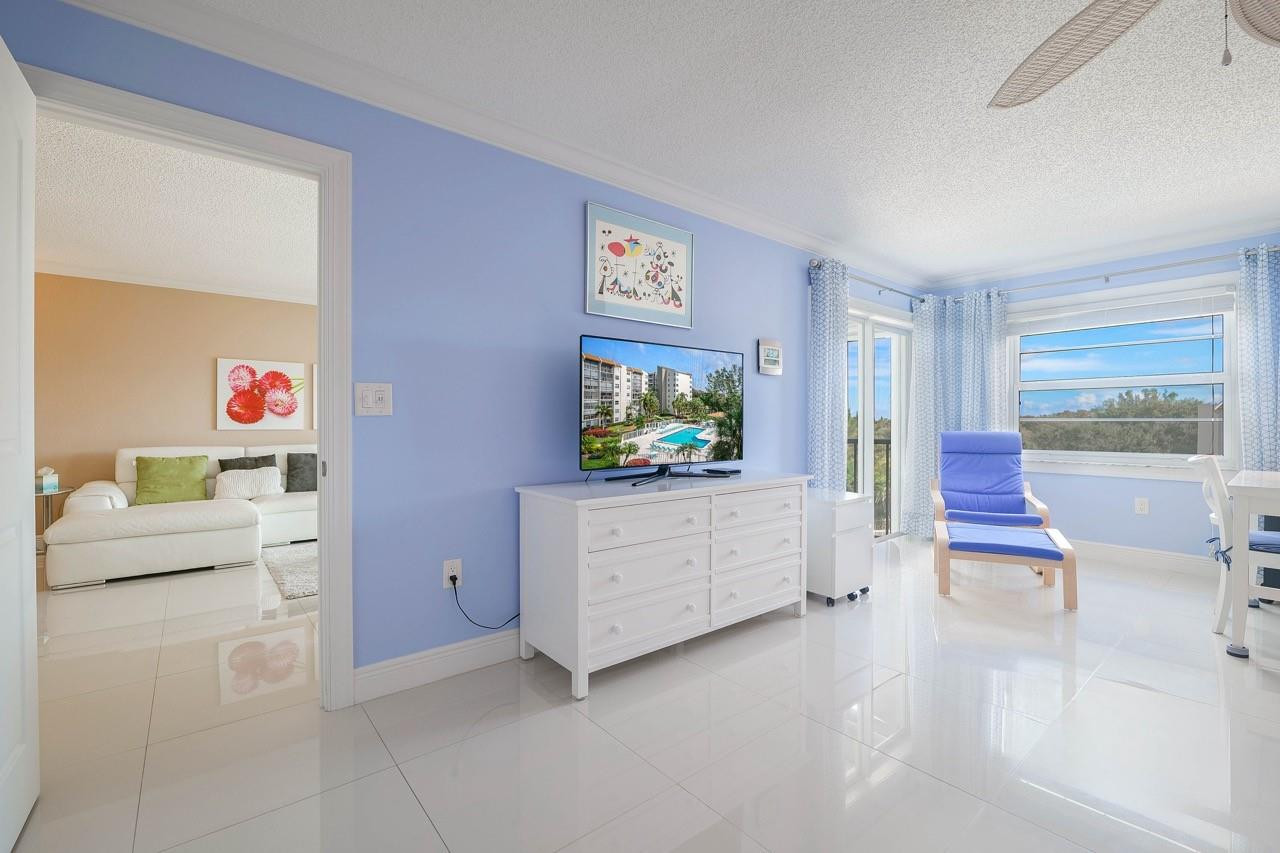 3930 Inverrary Boulevard, Unit 603D Lauderhill, FL 33319 - Photo 28 of 74 a living room with furniture and a flat screen tv