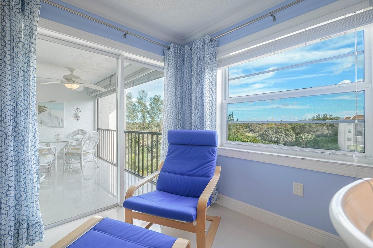 3930 Inverrary Boulevard, Unit 603D Lauderhill, FL 33319 - Photo 30 of 74 a living room with furniture and a floor to ceiling window
