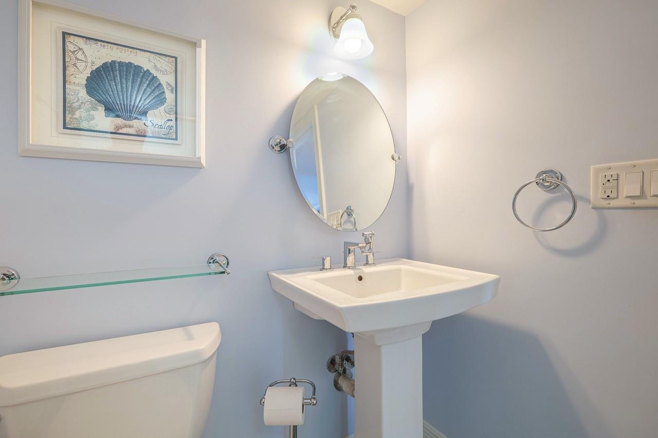 3930 Inverrary Boulevard, Unit 603D Lauderhill, FL 33319 - Photo 35 of 74 a bathroom with a toilet a sink and mirror
