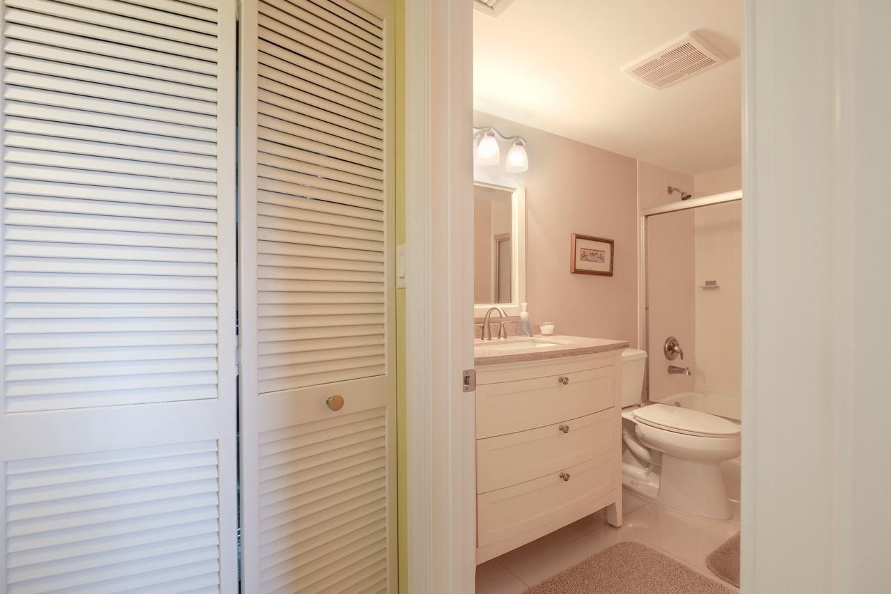 3930 Inverrary Boulevard, Unit 603D Lauderhill, FL 33319 - Photo 37 of 74 a bathroom with a toilet a sink and a mirror