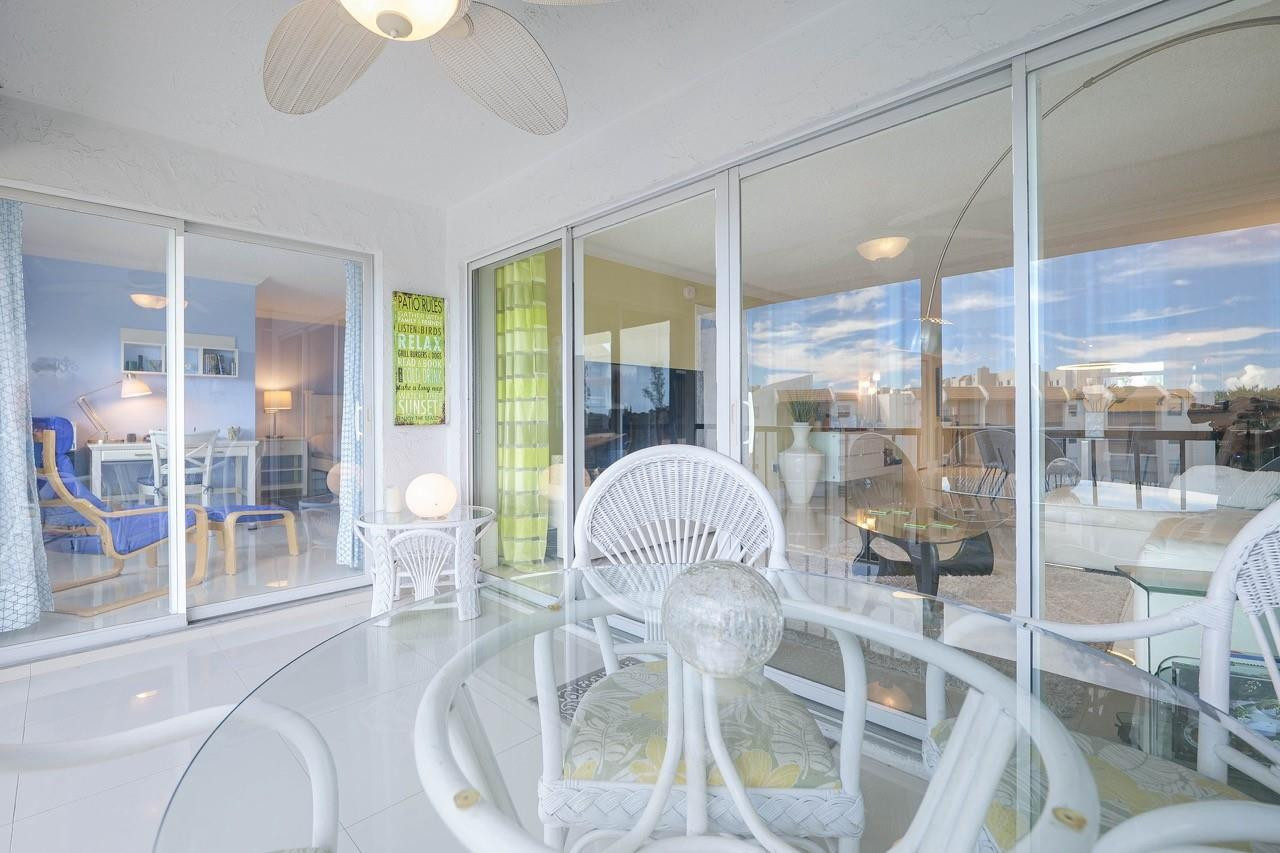 3930 Inverrary Boulevard, Unit 603D Lauderhill, FL 33319 - Photo 6 of 74 a dining room with furniture a chandelier and glass door