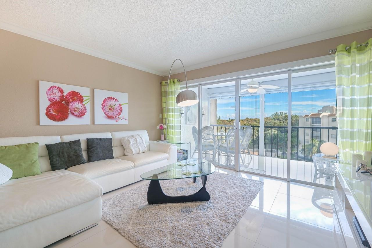 3930 Inverrary Boulevard, Unit 603D Lauderhill, FL 33319 - Photo 8 of 74 a living room with furniture and a large window
