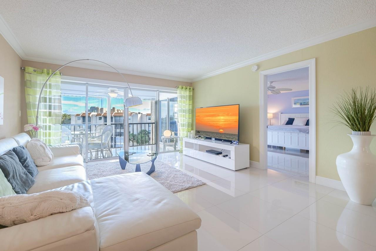3930 Inverrary Boulevard, Unit 603D Lauderhill, FL 33319 - Photo 9 of 74 a living room with furniture and a flat screen tv