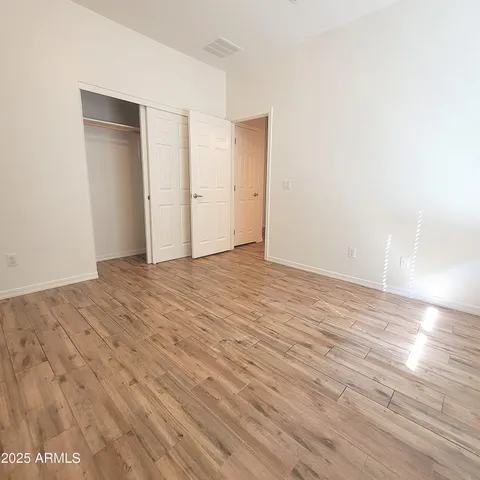 a view of an empty room and wooden floor