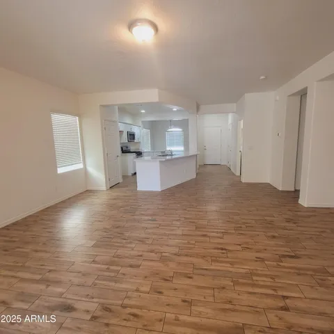 a view of a kitchen with wooden floor and a sink