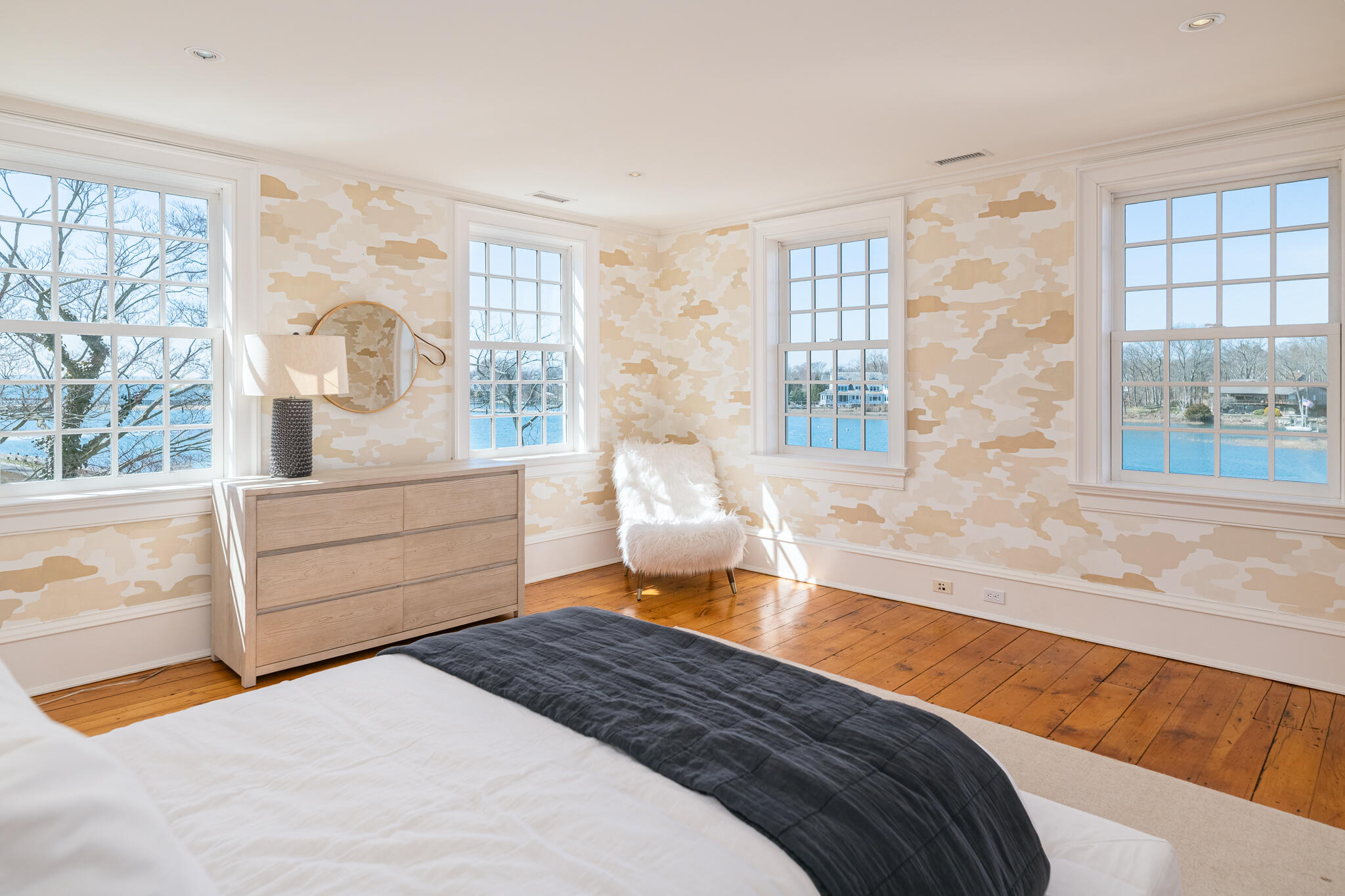 98 Pear Tree Point Road Darien, CT 06820 - Photo 21 of 42 a bedroom with a bed and wooden floor