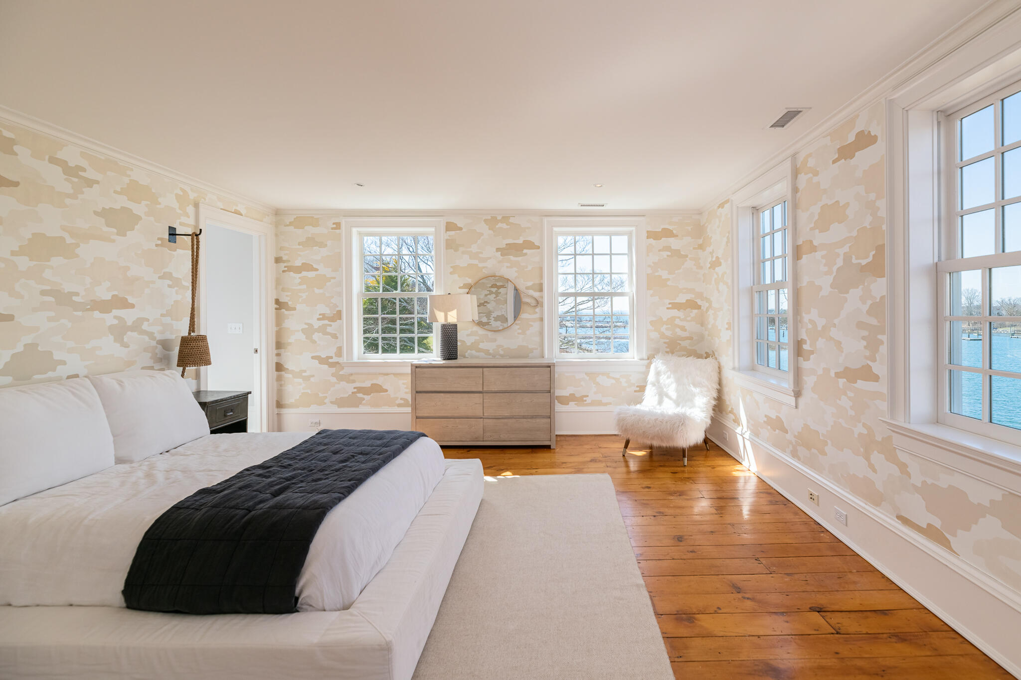 98 Pear Tree Point Road Darien, CT 06820 - Photo 22 of 42 a spacious bedroom with a large bed and a large window