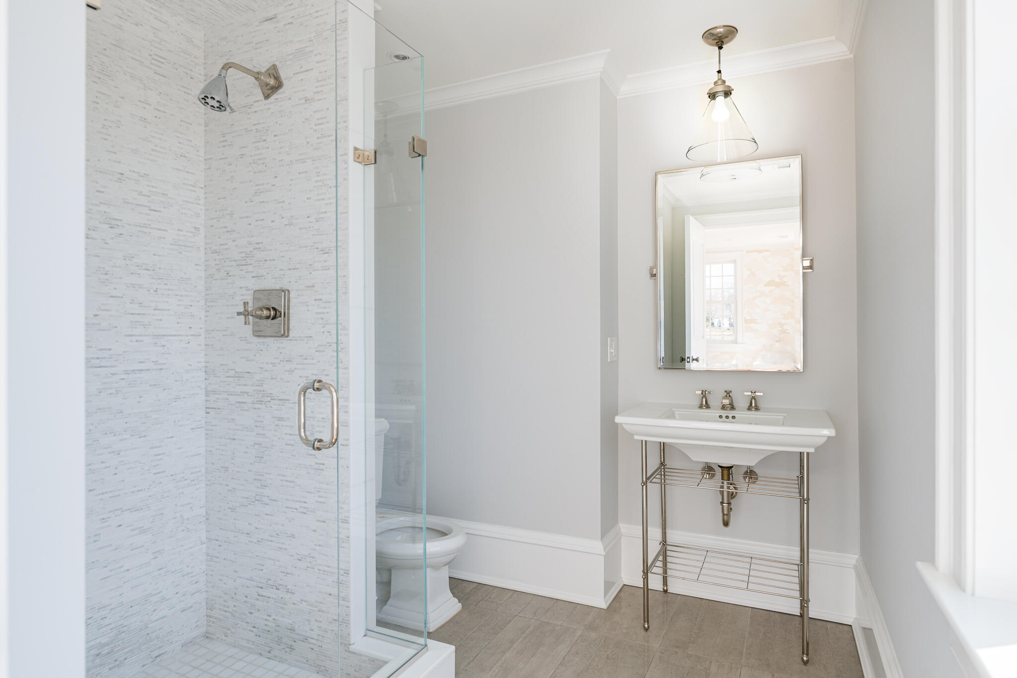 98 Pear Tree Point Road Darien, CT 06820 - Photo 23 of 42 a bathroom with a toilet a sink a mirror and shower