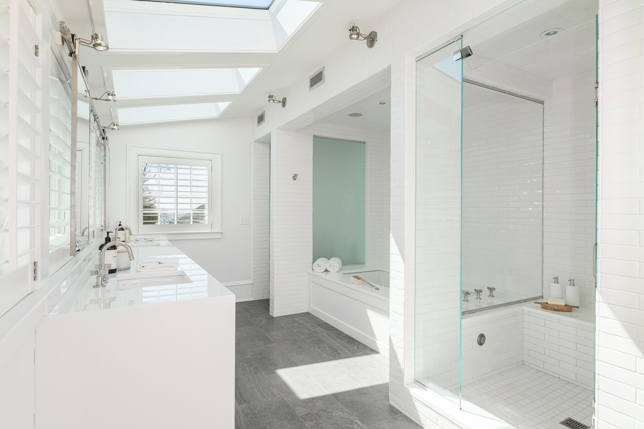 98 Pear Tree Point Road Darien, CT 06820 - Photo 26 of 42 a en suite bathroom with a sink a mirror and a shower