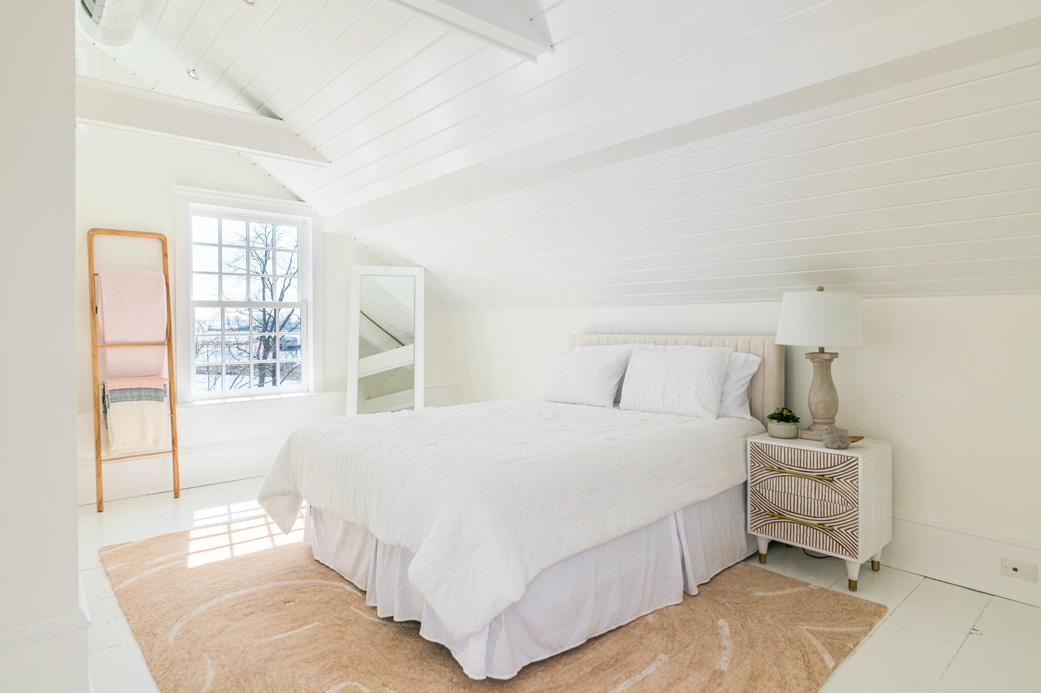 98 Pear Tree Point Road Darien, CT 06820 - Photo 30 of 42 a bedroom with a bed and a large window