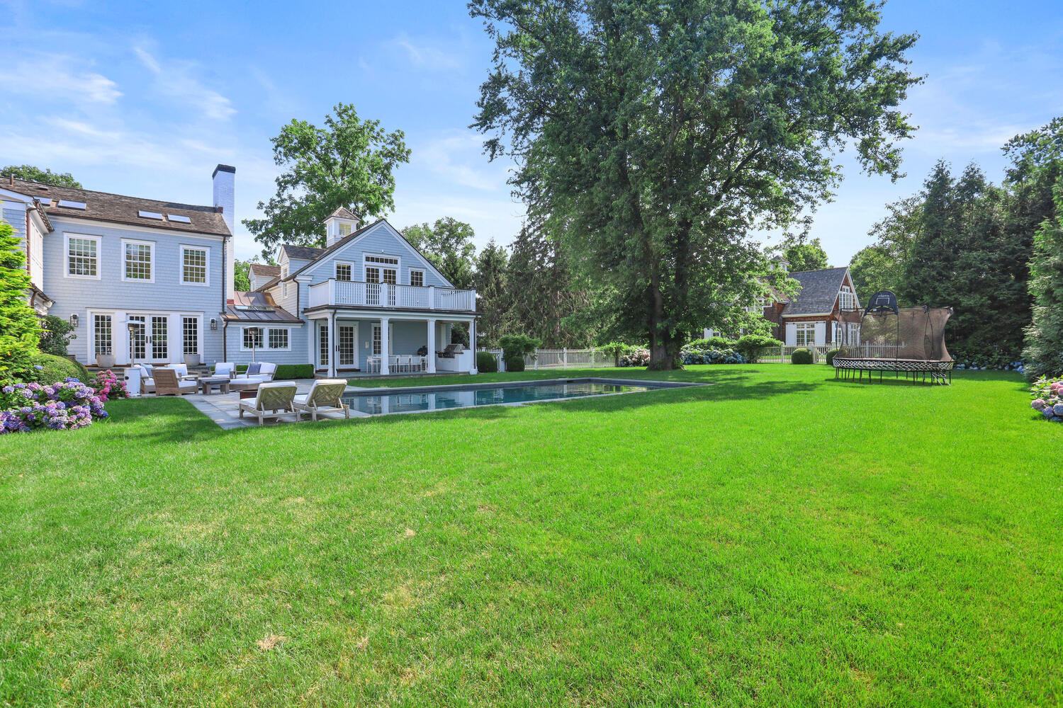 98 Pear Tree Point Road Darien, CT 06820 - Photo 35 of 42 a front view of a building with a garden