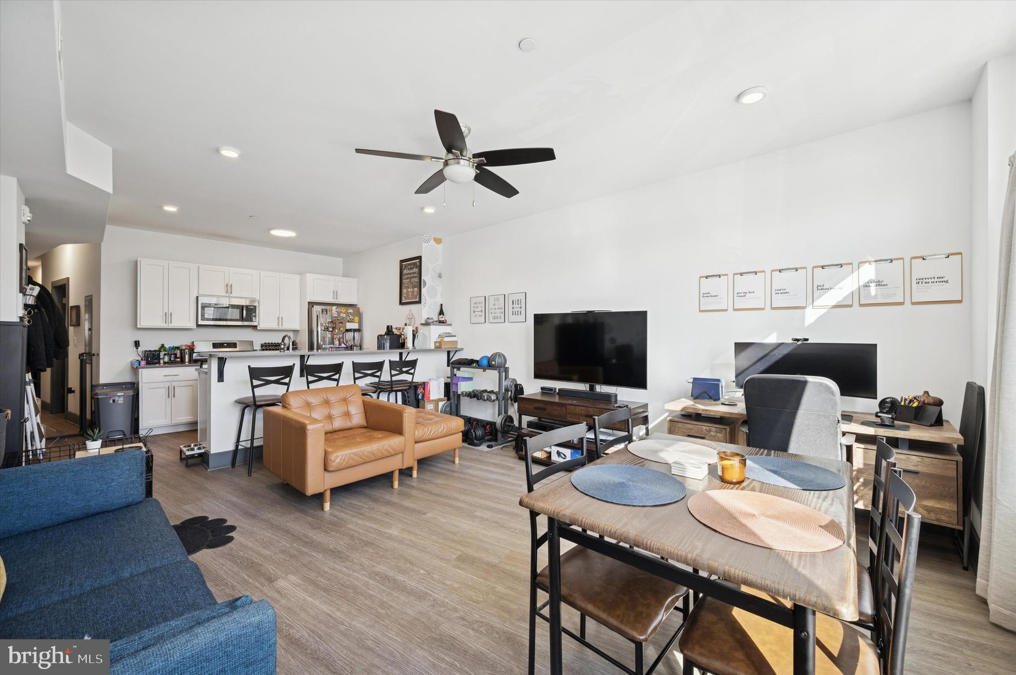 124-28 Levering Street, Unit 2B Philadelphia, PA 19127 - Photo 5 of 21 a living room with furniture kitchen view and a flat screen tv