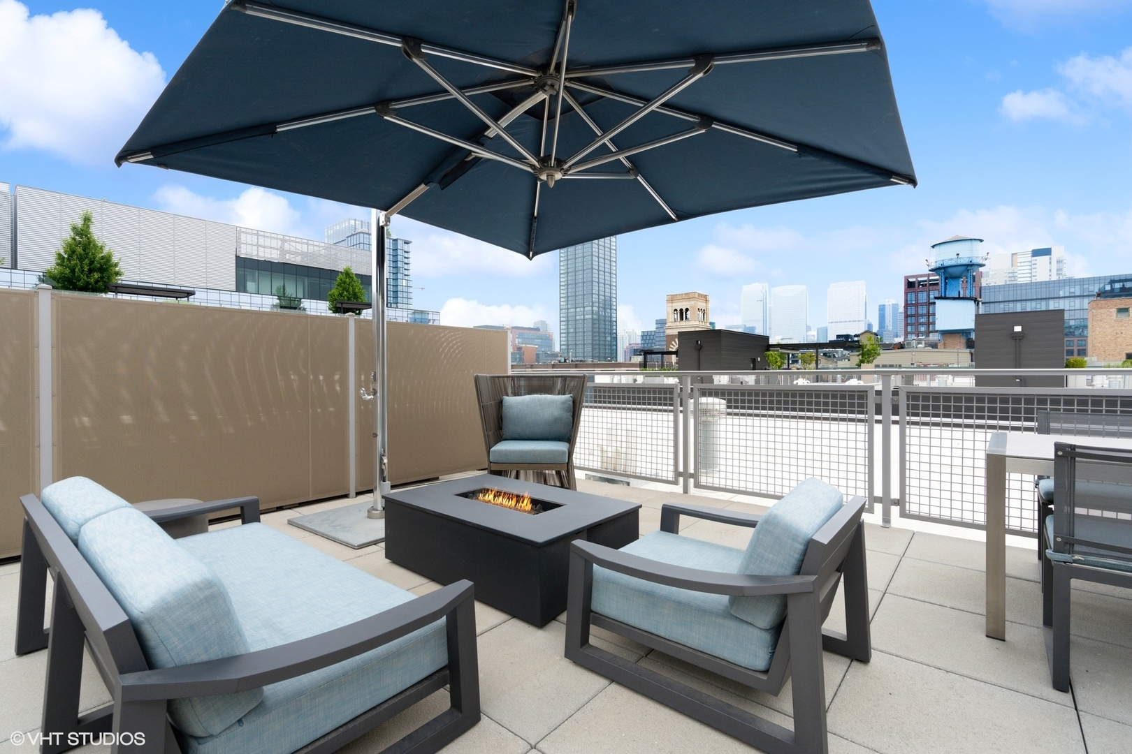 35 North Aberdeen Street, Unit PHS Chicago, IL 60607 - Photo 33 of 38 a view of a patio with a table and chairs under an umbrella