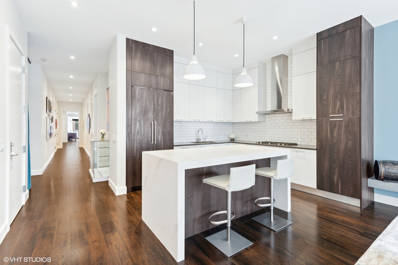 35 North Aberdeen Street, Unit PHS Chicago, IL 60607 - Photo 8 of 38 a kitchen with a table chairs refrigerator and wooden floor