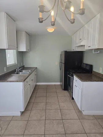 a large kitchen with cabinets and stainless steel appliances