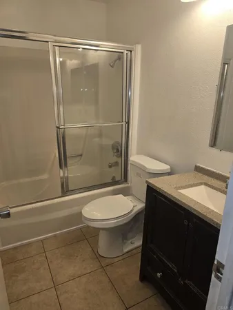a bathroom with a toilet a sink and shower