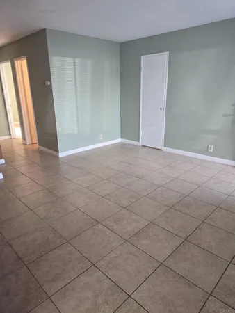 a view of an empty room and a window