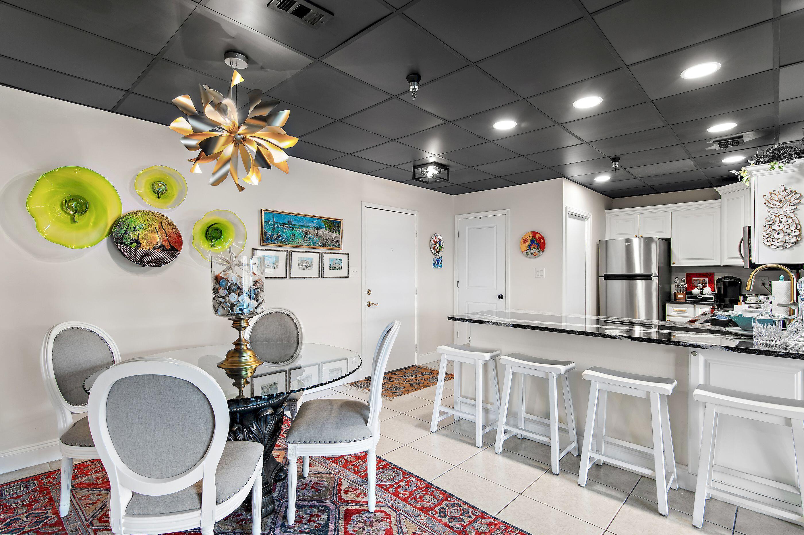 197 Durango Road, Unit 2B Destin, FL 32541 - Photo 11 of 29 a kitchen with a dining table and chairs