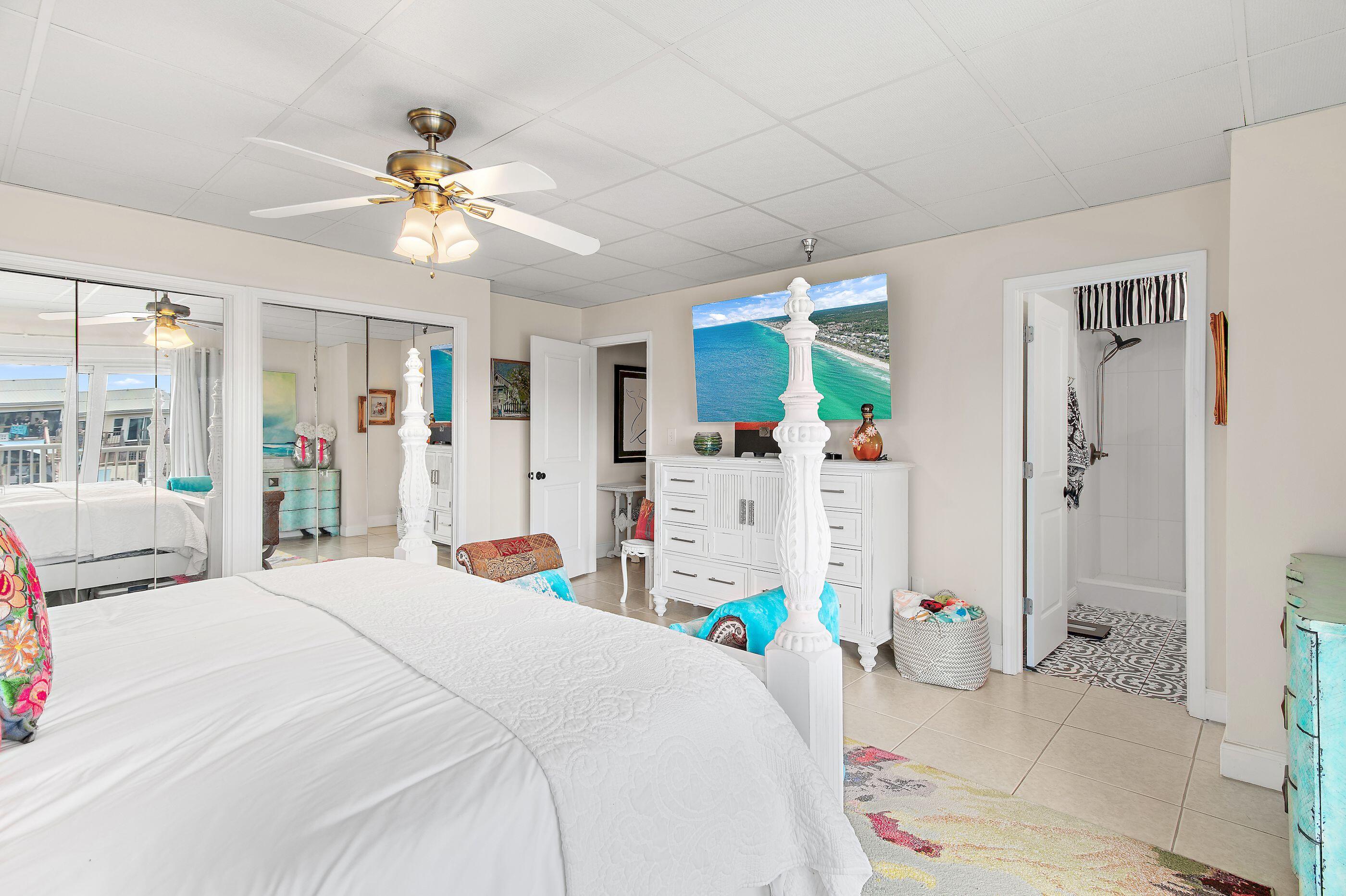 197 Durango Road, Unit 2B Destin, FL 32541 - Photo 13 of 29 a bedroom with a bed and ceiling fan