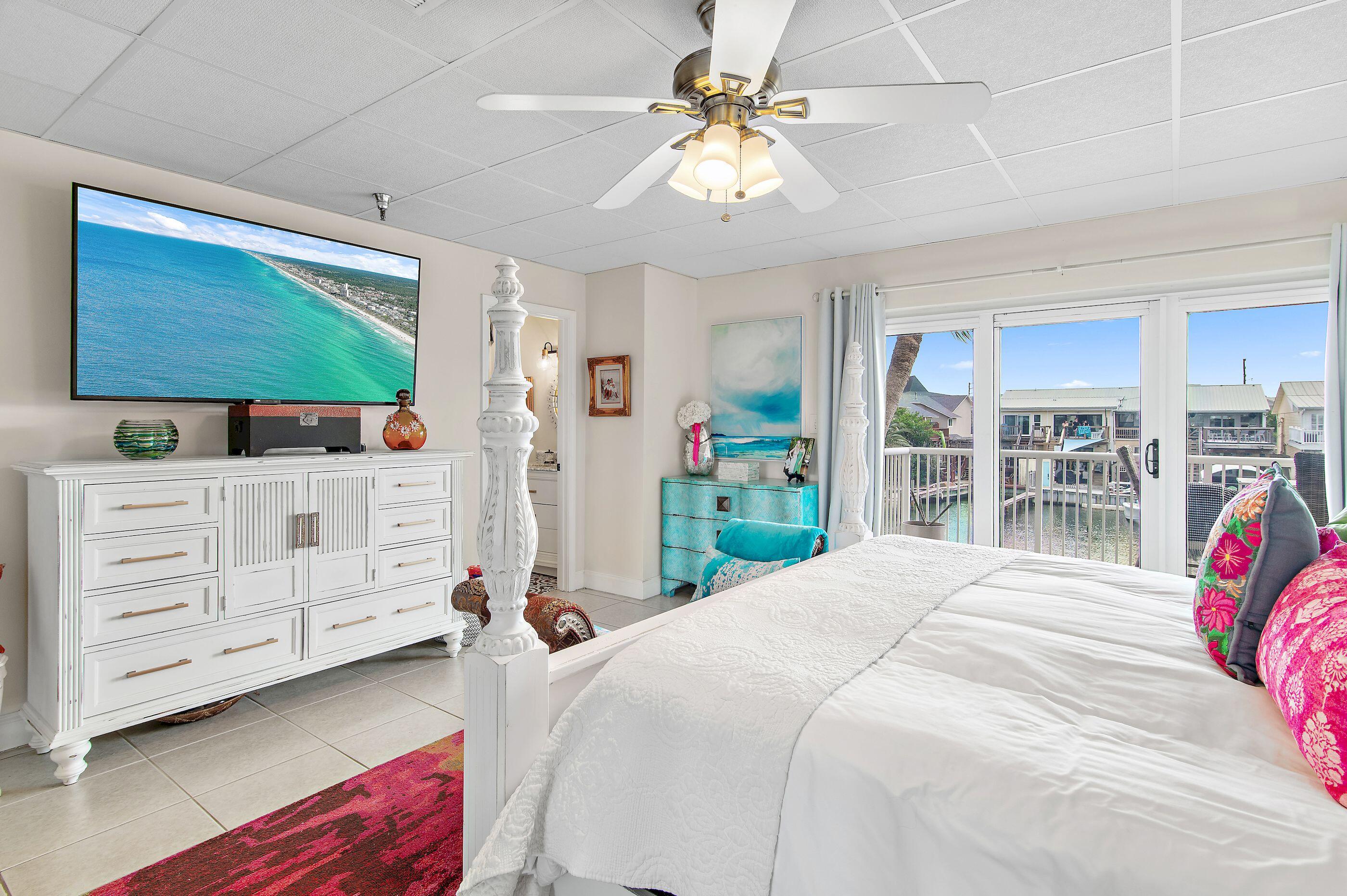 197 Durango Road, Unit 2B Destin, FL 32541 - Photo 14 of 29 a bedroom with a bed closet and flat tv screen