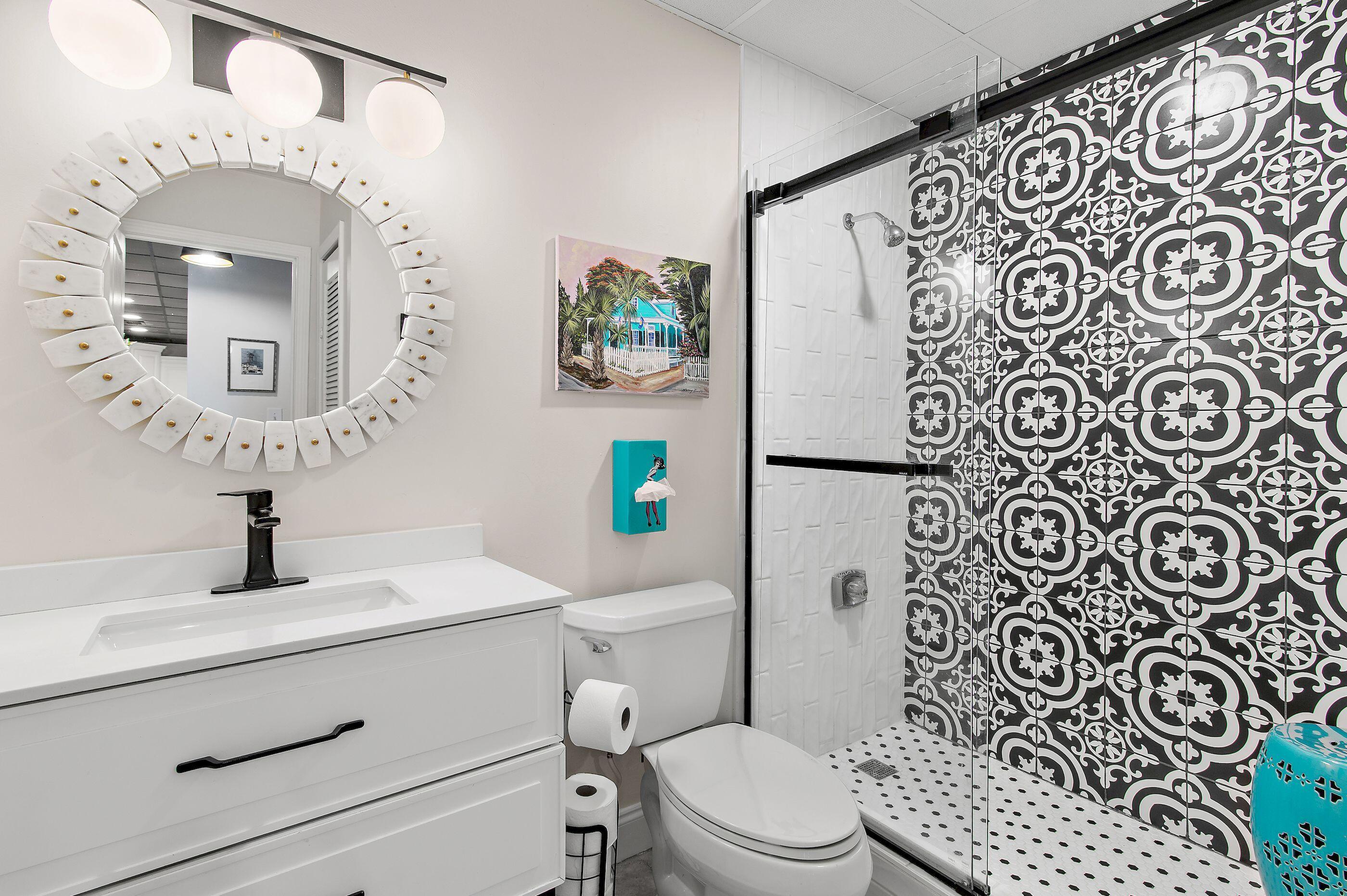197 Durango Road, Unit 2B Destin, FL 32541 - Photo 18 of 29 a bathroom with a toilet sink and mirror