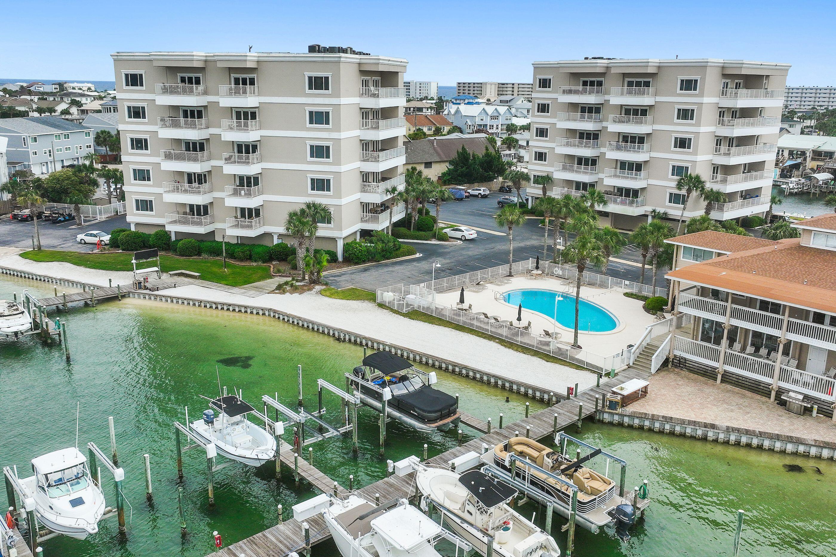 197 Durango Road, Unit 2B Destin, FL 32541 - Photo 26 of 29 a view of building with swimming pool outdoor seating