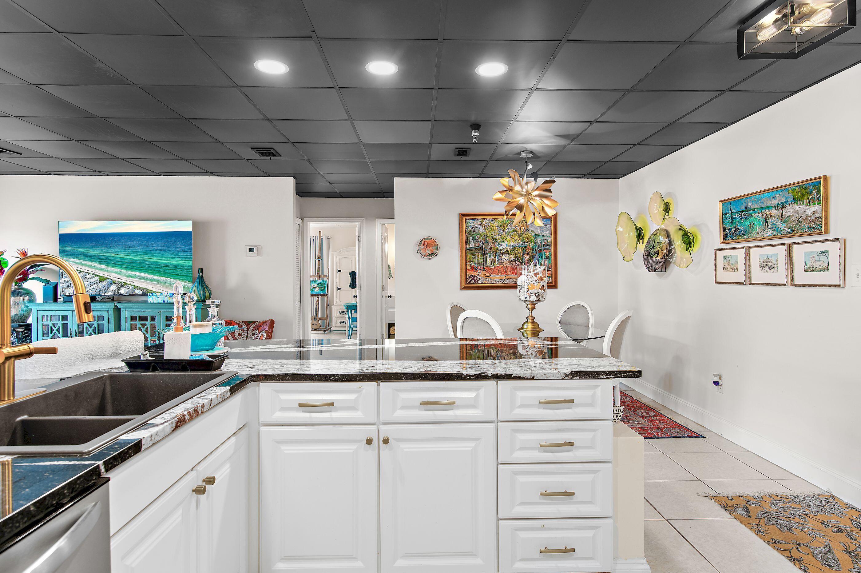 197 Durango Road, Unit 2B Destin, FL 32541 - Photo 9 of 29 a kitchen with stainless steel appliances granite countertop a sink a stove and cabinets
